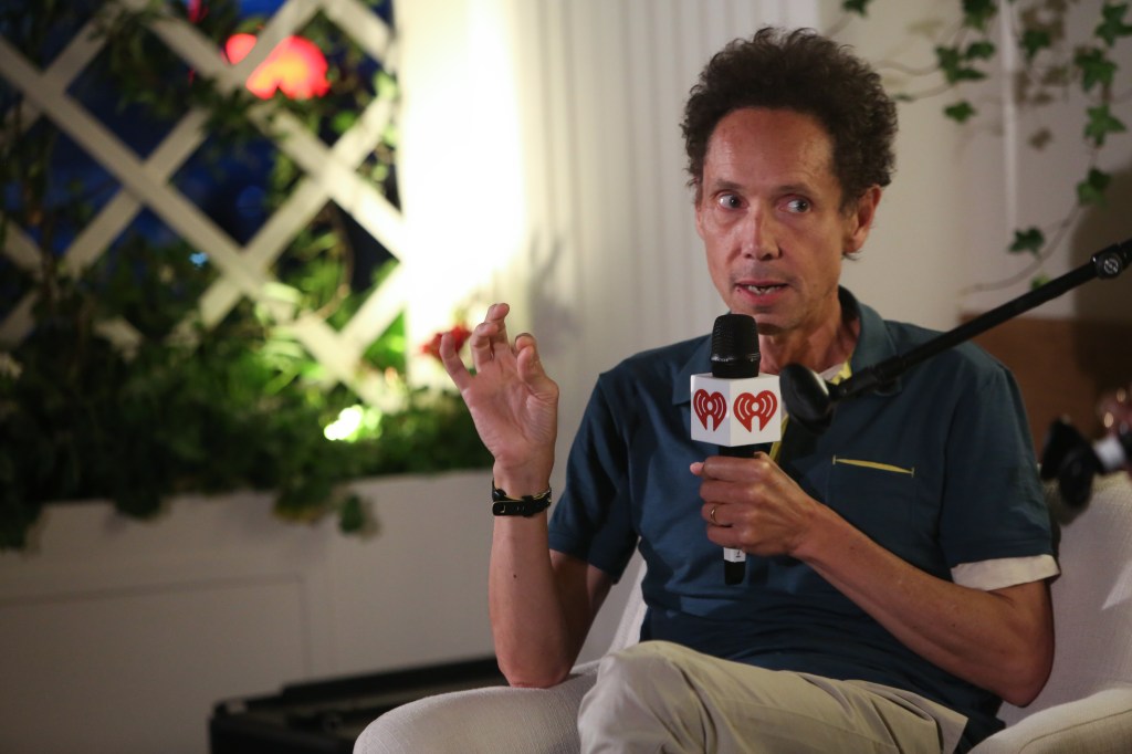 Malcolm Gladwell talking in a microphone.